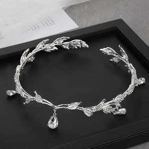 Silver leaf crown with rhinestones and crystal teardrop pendants on black tray