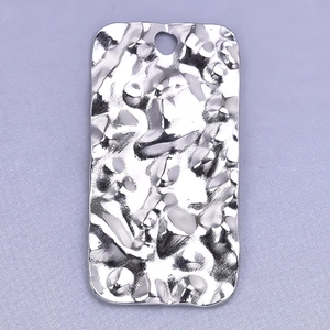 Detail shot of rectangular water ripple texture pendant in polished stainless steel finish
