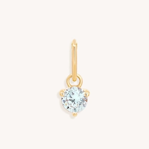 Macro view of a gold plated stainless steel pendant with a clear zircon stone setting