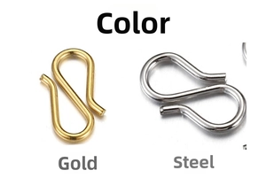 Macro detail of S-shaped stainless steel jewelry clasps in gold and steel finishes