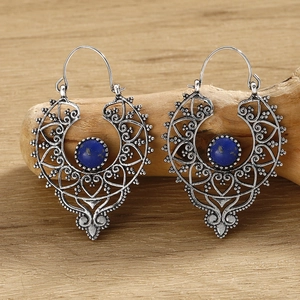 Macro detail of retro silver leaf-pattern earrings with inlaid round turquoise stone