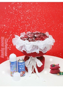 Christmas decoration set with faux red roses and artificial snow spray cans for festive scenes
