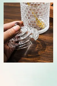 Macro detail of honeycomb textured glass storage jar lid with spherical handle