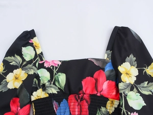 Detail of floral square neck blouse with smocked bodice and puff sleeve design