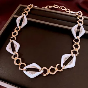 Vintage geometric necklace set with gold links and diamond-encrusted white diamond charms