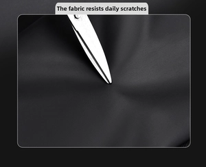 Close-up of durable black nylon crossbody bag showing scratch-resistant fabric with scissors