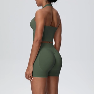 Detail showing high-waisted olive green fitness shorts with contouring lift line