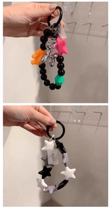 Detailed macro view of colorful silicone star beads and silver metal balloon dog keychain