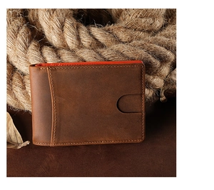 Detail of vintage brown crazy horse leather wallet with orange lining and rustic decor