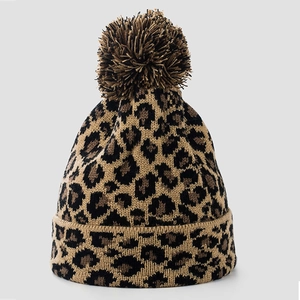 Winter leopard print knit beanie featuring a fluffy pom-pom and thick cuff for unisex warmth