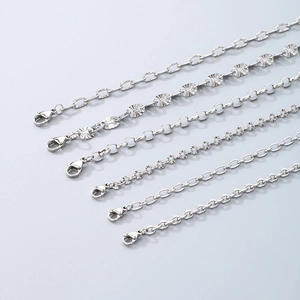Close-up of various silver-toned chain styles with lobster clasps and unique textures