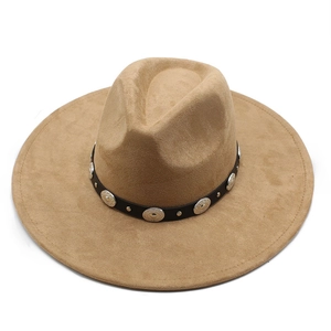 Detail of khaki wide-brim fedora hat with black band and silver metal studs decoration