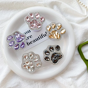 Detailed view of cat paw phone grips with sparkling rhinestones in five various colors