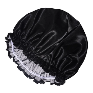 Detail of double-layered waterproof satin shower cap with elastic band and ruffles in black