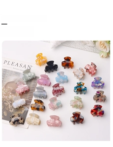 Flat lay of small 3cm hair claw clips in tortoise shell and marble acetate patterns
