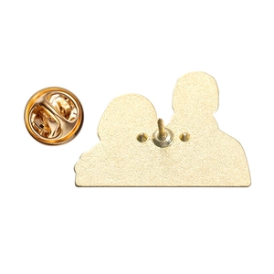 Detailed macro view of the metal brooch back featuring gold clutch pin and butterfly clasp