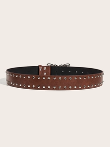 Close-up of brown studded leather belt with dark metal butterfly buckle and silver rivets