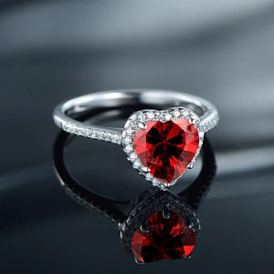 Elegant S925 silver ring featuring a heart-shaped red gemstone with zircon halo setting