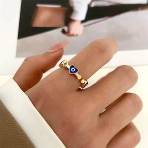 Detail of 14k gold plated evil eye heart ring with blue oil drip and zircon inlay