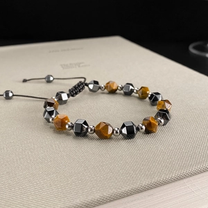 Macro shot of tiger eye and hematite beads with adjustable woven cord for men and women