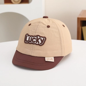 Close-up of Lucky letter embroidery and soft brim on kids color-block baseball cap