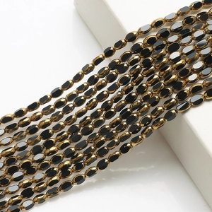 Macro shot of 4x6mm black and gold glass beads strands for DIY jewelry making