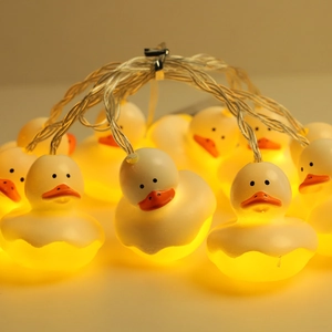 Christmas LED string lights with warm yellow glowing cartoon duck decorations