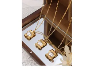 Detail of vintage gold pearl necklace with irregular square pendant on a mirror surface