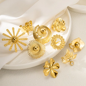 Elegant gold flower and butterfly rings set on white silk for a vintage minimalist look
