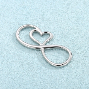 Silver stainless steel heart and infinity symbol pendant on a light blue textured background