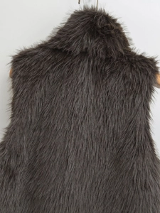 Detailed back view of dark grey faux fur vest showing fluffy long plush texture