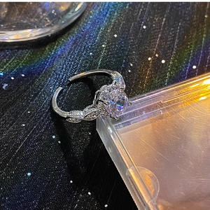 Detail of silver adjustable ring with round zircon and twisted pave setting band