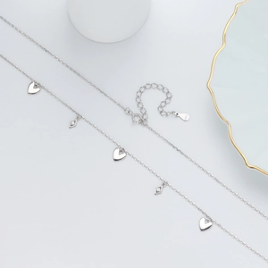 Elegant 925 sterling silver necklace with heart and diamond-shaped charms on white base