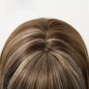 Detail of synthetic long wavy wig showing realistic scalp parting and blonde highlights