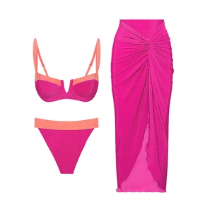 Three-piece bright pink bikini set with glitter texture and matching sarong wrap skirt