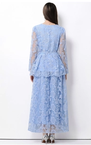 Detail of light blue lace embroidery dress with tiered skirt and refined floral patterns