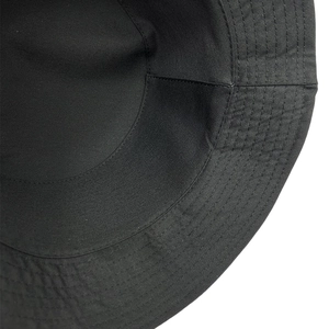 Detail view of reinforced stitching on the inner sweatband of a black canvas bucket hat