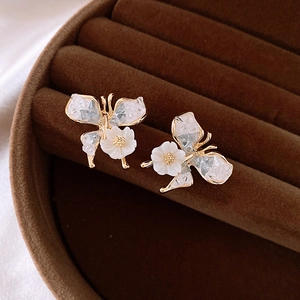 Elegant gold butterfly and flower stud earrings with crystals in a velvet jewelry box