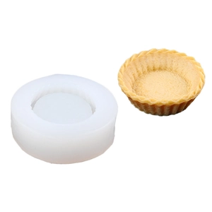 Macro detail of a white silicone tart mold with a finished golden pastry crust shell