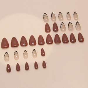 Almond-shaped press-on nails featuring glossy deep brown and leopard print French tips