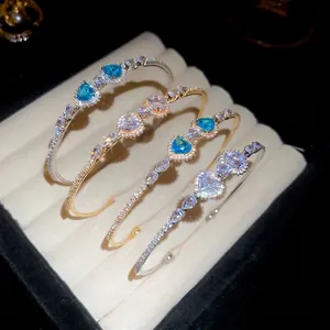 Luxurious open heart bracelets with sea blue zircon stones and silver or gold plating