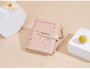 Detail of pink fold wallet featuring cartoon bear patterns and secure metal zipper
