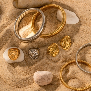 18K gold plated vintage jewelry set with square emerald zircon on natural sand background
