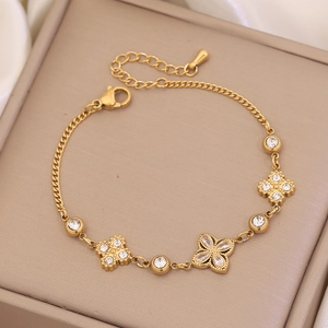 Double-layered golden titanium steel bracelet featuring rhinestone clover and pearl accents