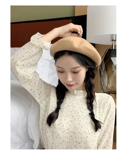 Close-up of khaki wool beret showing premium felt texture and warm autumn fashion style