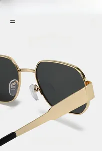 Close-up of golden polygon metal frame sunglasses featuring lightweight flexible temples