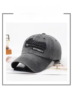 Macro detail of dark grey washed cotton baseball cap with 3D embroidery and vintage texture