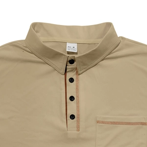 Close-up of khaki polo shirt collar with orange contrast stitching and size M label