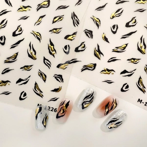 Minimalist gold and black tiger stripe nail stickers with metallic embossed finish