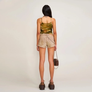Slim fit ink camouflage sports vest for women shown from the back with denim shorts